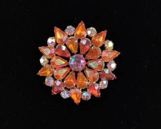 BIHY102 Vintage Rhinestone Brooch This is a beautiful vintage rhinestone brooch. The brooch features vibrantly iridescent orange and white rhinestones, with hints of pink, purple,&nbsp;blue, and green

