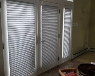 Sliding glass doors; Hunter Douglas shades throughout home