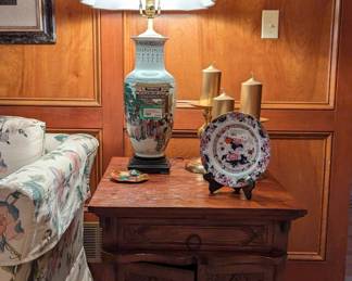 The other  hand-carved wooden side table, with single drawer/two doors, Asian porcelain table lamp, hand-carved gold-painted wooden fish, one of a pair of Asian porcelain plates on stands and set of 3 pillar candles on brass stands. 