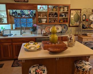 Kitchen full of yummies. There's a pair of wooden kitchen stools, Italian hand-painted glazed terra cotta lemon tray, baker's rack, pair of nicely framed Chelsea House botanical prints, Canadian breakfast table by Canadel, Inc., pots, pans, etc.