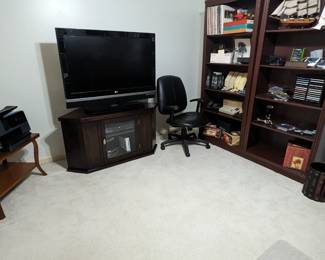 Large flat screen TV, wooden TV stand, Hewlett-Packard color printer, etc.