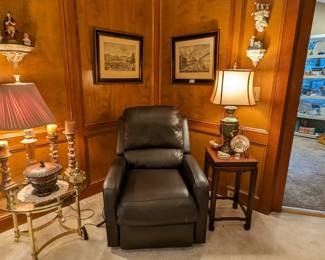 One of the pair of real leather power recline/lift chairs, square, Asian-inspired wooden side table, round brass/glass side table, pair of nicely framed Maitland-Smith architectural prints, wall sconces with hand-painted porcelains and Royal Doulton porcelain figurines. 