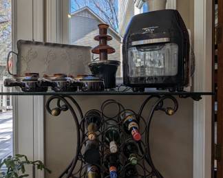 Nice wine rack, w/glass top, air fryer, chocolate fountain and glazed terra cotta French onion soup bowls. 
