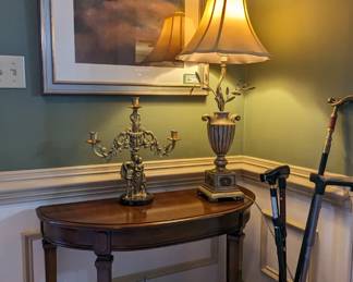 Nicely framed/matted contemporary original art, Canadian wooden entry table, resin table lamp and pottery jug with walking canes. 