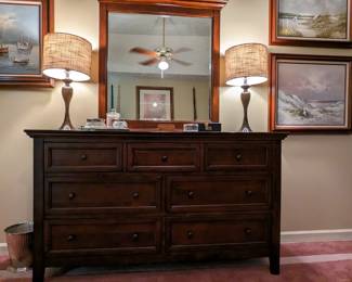 7-drawer wooden dresser, with pair of table lamps, mirrored vanity tray and vintage powder jars