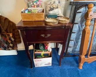 Sewing table with built-in Precision "Universal" sewing machine, sewing notions and fabric remnants.
