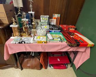 Vintage bowling trophies, golf balls and a set of vintage Tyco Ho-scale plastic train cars.