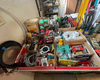 Mixed lot of tools and hardware for electrical and plumbing work.