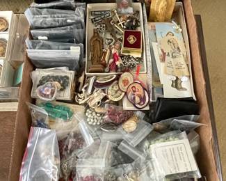 Large collection of religious items, including rosaries, scapulars and medals.