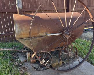 Handmade smoker cooker from antique wagon, wheels, and parts