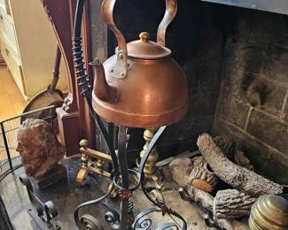 Old copper pot on stand.
