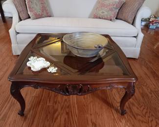 Ornate, mahogany,  glass topped, square coffee table.  Large pottery Midnight bowl.  Lovely sofa