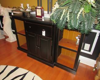 black sideboard, clock, statues, florals