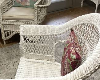 Two more white wicker chairs