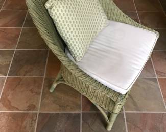 One of a pair of vintage wicker chairs