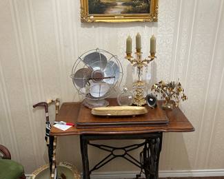 Antique singer sewing machine in cabinet, antique fan