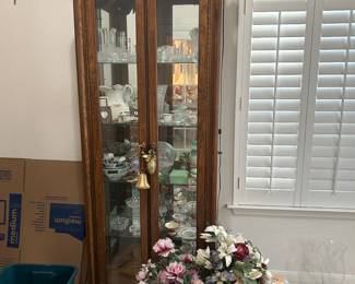 Curio cabinet full of crystal and collectible glass