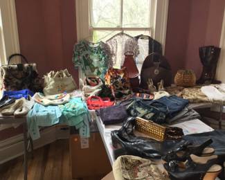 Overview of vintage clothing, t-shirts, pants, jeans, purses, leather boots, wedge shoes