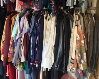 Overview of vintage clothing, mostly men's shirts, coats, jackets, vests, sweaters