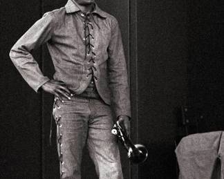 A photographic print of Miles Davis with his trumpet on stage at the 1969 Newport Jazz Festival in Newport, Rhode Island. Limited edition of 50 prints from the original negatives taken by Andrew Sacks, fused to foam board. Signed "Andrew Sacks" and dated "1969" lower right, numbered "4/50" lower center and titled lower left. Image14 3/4 x 21 3/4" high, foam board 20 x 30" high overall.