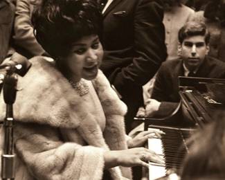 A photographic print of Aretha Franklin performing on the piano during a 1969 performance at the University Events Building (Crisler Arena) in Ann Arbor, Michigan. Limited edition of 50 prints from the original negatives taken by Andrew Sacks, fused to foam board. Signed "Andrew Sacks" and dated "1969" lower right, numbered "4/50" lower center and titled lower left. Image 14 3/4 x 21 3/4" high, foam board 20 x 30" high overall.