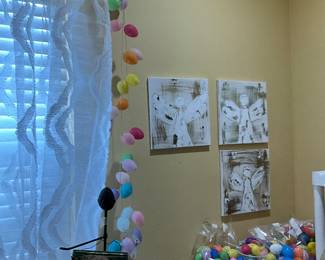 Easter egg garlands at window, 3 angel pictures above Easter eggs 