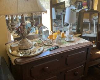 Lamp & vintage dresser in bedroom on,left on left with items on top