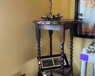 Table, picture, and broken brass candelabra 