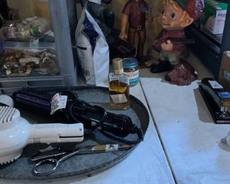 Cherub, carving of man holding tool chest, hunter with dog at feet, miscellaneous items in metal tray, curved stand mirror (vintage)