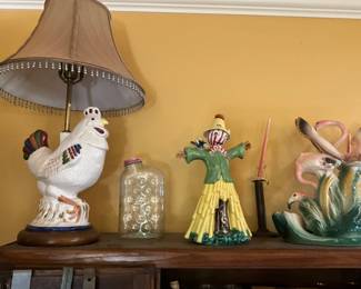 Top of Hoosier cabinet -chicken lamp, vintage refrigerator water bottle, the ceramic clown and the Lane & company flamingos!