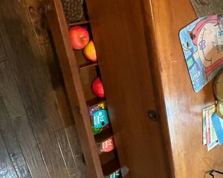 Table with lower drawer filled with items 