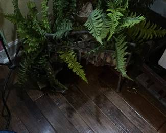 Artificial fern in antique metal piece