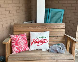 Rocking bench on porch with pillows 