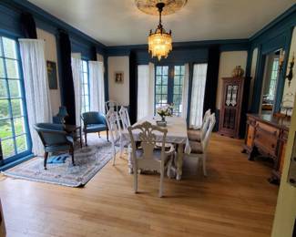 White dining room table with extensions, up to 100” long.  Shabby chic chairs (6 regular, 2 with arms) with high end fabric seats.  Two retro blue vinyl chairs with wheels. 