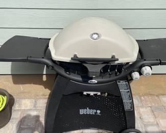 Weber Grill with stand, tank and cover.                56"w open 21"d 44"t