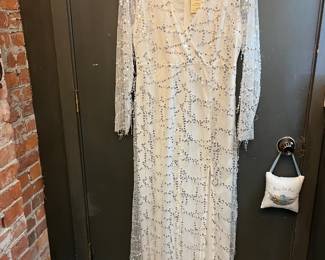 Southern Fried Chics long white sequins dress. Size XL. Does have leg slit in the front and zipper in the back.
Few stains on the bottom of the dress.