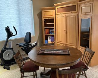 A stationary bike completes the workout.  We have a Copenhagen entertainment center and a vintage oak ball and claw pedestal table with four chairs.