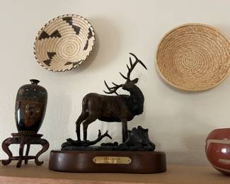 Bronze elk statue by L. Jung, pottery and baskets.