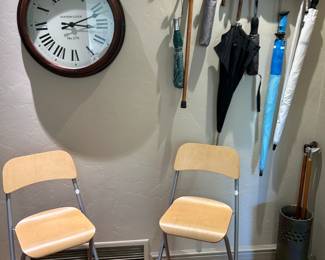 Wonderful kitchen clock, umbrellas and coat hooks, plus folding bistro chairs.
