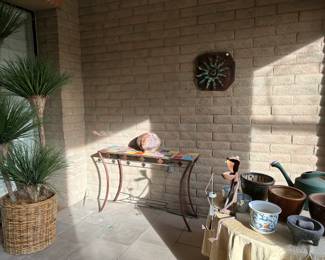 Lots of plants, pots, and artwork for your patio.