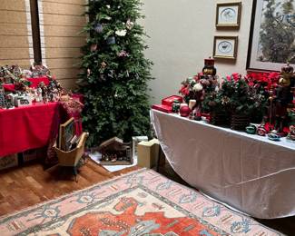 Balsam Hill Silverado Christmas tree with lights, Turkoman rugs, and lots of Christmas items.
