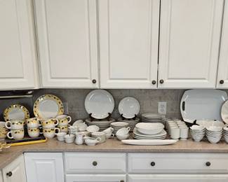 Kitchen showing white dish set and more