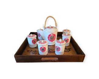 Teapot and cups on wooden tray