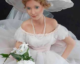 Seated Bride With Wide-Brimmed Hat And Basket Of Flowers

