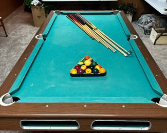 This MCM pool table is great! It's well loved and played, but would still. make a great addition to your MCM home! The lies fold up and can be carried upstairs! All the cues, rack and balls are included! 