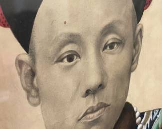 During the Qing Dynasty (1644-1912) every important family honored their ancestors via portraits such as this. Standing at over five feet high it is painted on paper mounted on a silk roll then affixed to a masonite base. The man's winter robe is in a deep blue - the official color of the Qing dynasty indicating he was a minor prince or nobleman. Fur collar and lining indicates he isa man of means along with his fur winter hat topped with a gold pendant embellished with precious stones. The square rank badge at the center of his robe includes a golden quail amidst clouds - a symbol of courage. Nearby is a "wan" the Chinese symbol which translated means "all things." 