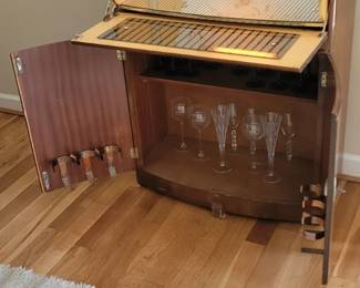 mirrored bar, cabinet below, lighting in top section