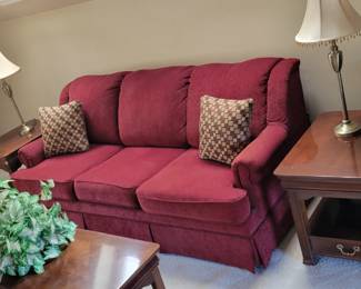 cranberry upholstered sofa, wire and wood bookshelf