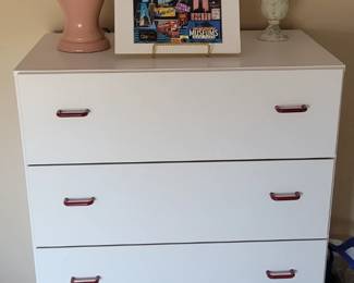 white laminate chest of drawers, decorative items