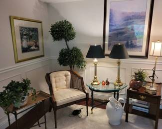 end tables , chair , art and décor. lots of artificial plants  